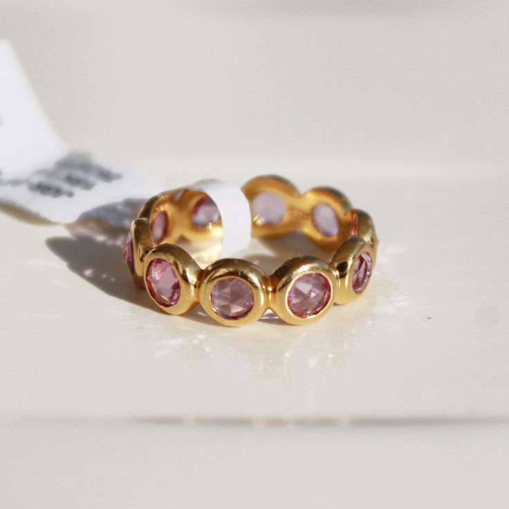 This ring with beautiful Natural sapphires, set in 18K Solid Gold. It is a ring perfect for any gifting occasions for your loved ones. Purchase the perfect gift for your mom, wife, grand mom, daughter, girlfriend, and fiancee. This ring, due to its design, can also be stacked easily with other rings. -Material - 18K Solid Yellow Gold -Gemstone - Natural pink Sapphire -Gemstone weight - 3.020 ct -Gross weight - 4.0 grams -Band Width - 5.25 mm Pink sapphires are recognized as having a variety of m Gold Stackable Rings With Pink Sapphire, Stackable Sapphire Ring In Yellow Gold, Gold Pink Sapphire Round Ring, Elegant Pink Sapphire Round Eternity Band, Gold Pink Sapphire Stackable Rings For Gift, Gold Stackable Rings With Pink Sapphire For Gift, Gold Stackable Rings With Pink Sapphire As A Gift, Gold Pink Sapphire Birthstone Ring Gift, Yellow Gold Sapphire Stackable Ring For Anniversary