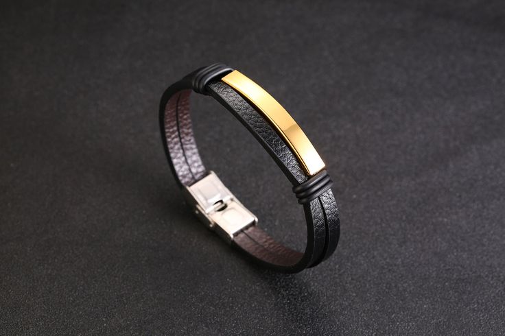 Timeless Sophistication: Leather and Stainless Steel Bracelet for Him Introducing our exquisite Men's Leather Bracelet, a harmonious blend of luxury and sophistication crafted with the finest materials. Men's Gold-Plated Leather Bracelet with Magnetic Clasp Leather: The bracelet features a genuine leather band, ensuring durability, comfort, and a touch of rugged elegance. Stainless Steel: Imbued with strength and resilience, the stainless steel components add a modern and polished aesthetic. Gold Plating: The subtle gold plating elevates the bracelet, infusing it with a sense of opulence and timeless appeal. Non-Repetitive Tessellation Leather Bracelet Not Tessellated: The bracelet boasts a distinctive design with an Engraving Plate and a Steel Secure Magnetic Sliding Clasp, creating a uni Minimalist Formal Bracelet With Leather Strap, Minimalist Leather Strap Bracelets For Formal Wear, Minimalist Leather Strap Bracelet For Formal Occasions, Black Leather Bracelet With Stainless Steel Clasp For Business, Luxury Leather Bracelets For Business, Adjustable Rectangular Leather Bracelet In Luxury Style, Modern Leather Bracelet For Business, Classic Rectangular Leather Bracelets, Luxury Leather Strap Bracelets For Business