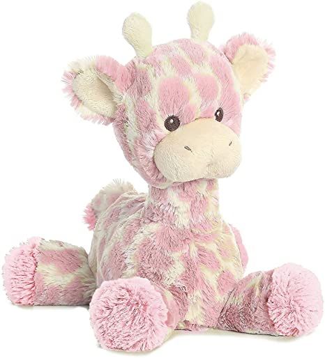 a pink giraffe stuffed animal sitting on the ground