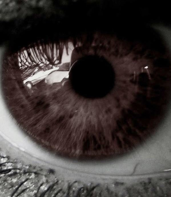 an extreme close up shot of the iris of a person's eye, looking into the distance