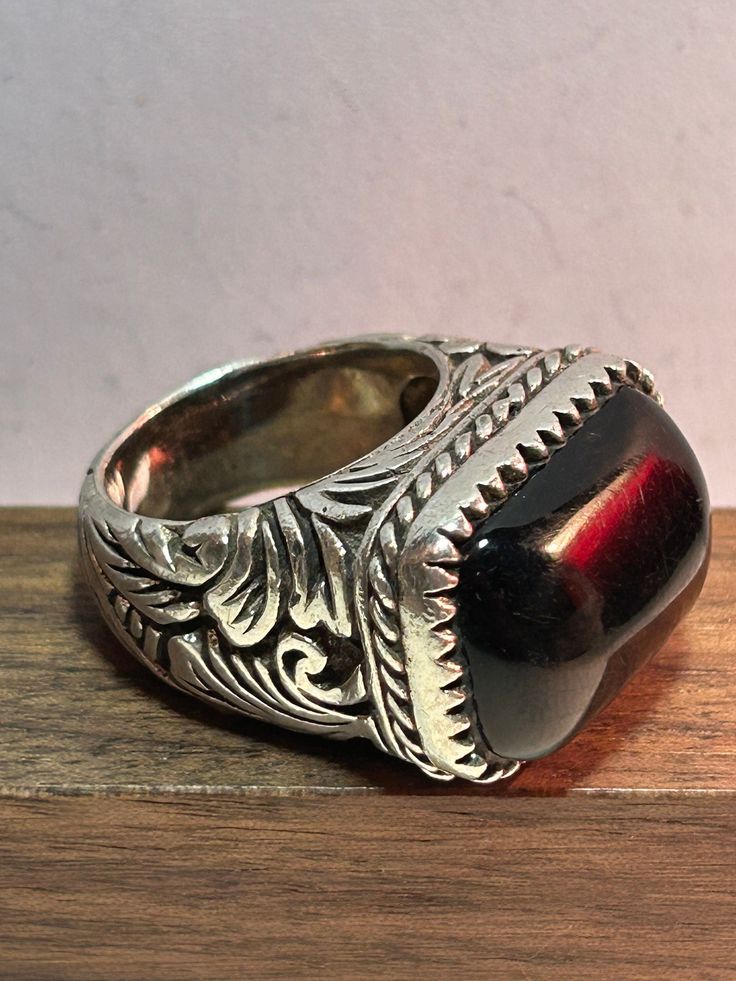 This is a HUGE, stunning, vintage, genuine Barse black onyx and sterling silver ring. The ring is a size 8 1/2 and could easily be resized by a jeweler if needed larger or smaller. The rectangular ring features a rectangle-cut black onyx stone set in a sawtoothed sterling silver bezel. The stone measures nearly 1" long by 5/8" tall. The ring band has an ornate design that is a sterling silver rope beneath the onyx setting and then a scrolling vine with leaves pattern on the ring band top, bottom Black Vintage Engraved Ring Stamped 925, Black Vintage Engraved Ring With Polished Finish, Unique Black Signet Ring For Anniversary, Black Engraved Gemstone Ring For Anniversary, Vintage Black Engraved Ring For Gift, Black Vintage Engraved Ring, Vintage Black Engraved Ring Gift, Collectible Black Rings With Polished Finish, Black Sterling Silver Engraved Ring For Anniversary