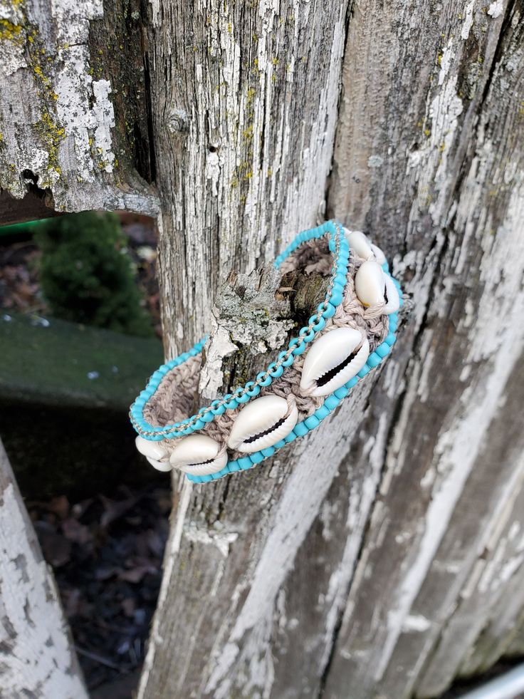 "Chunky Boho Cowrie Shell Beaded Bracelet Beach Wedding Jewelry Eclectic ethnic, tribal-inspired boho chic jewelry, crocheted, handcrafted in Queens, NY. *I made a few shell & hemp jewelry for an island photoshoot - see all the new posts soon! Right now I don't have shows and festivals, I have a little time to make these. A chunky crocheted and beaded hemp bracelet with a loop & knob closure. There are 11 shells & 87 beads on this! 1\" wide, 7\" long - custom size is available! Last 2 photos; Th Artisan Hand Wrapped Beaded Bracelets For Beach, Adjustable Bohemian Bracelets With Cowrie Shell, Bohemian Cowrie Shell Friendship Bracelets As Gift, Adjustable Bohemian Beaded Bracelets With Cowrie Shell, Bohemian Cowrie Shell Bracelet Gift, Bohemian Cowrie Shell Gift Bracelet, Bohemian Crochet Jewelry With Round Beads, Turquoise Beaded Braided Bracelets For Festivals, Turquoise Beaded Braided Bracelet For Festival