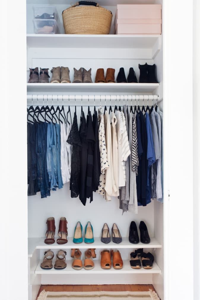 an organized closet with clothes and shoes