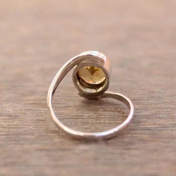 Gemstone - CitrineGemstone Size - 10x08 oval Metal - Sterling SilverCitrine attracts wealth and helps you to overcome negative emotions, citrine also knows as the stone of success.To change the ring size i request the buyer to pull the band lock in the opposite direction. This Fabulous ring is made by granulation technique by soldering each ball precisely and wrapping the silver wire around the collet manually.The ring can be customized on request and gemstone can be switched to any gemstone you Silver Citrine Crystal Promise Ring, Silver Citrine Birthstone Ring For Anniversary, Adjustable Oval Topaz Ring For Anniversary, Silver Citrine Birthstone Ring, Oval Citrine Birthstone Ring For Anniversary, Unique Oval Sapphire Birthstone Ring, Anniversary Citrine Open Ring, Gemstone Bypass Promise Ring, Oval Citrine Birthstone Crystal Ring