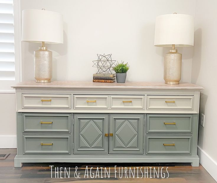 two lamps on top of a dresser in a room with white walls and wood floors