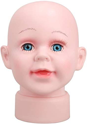 a pink doll head with blue eyes on a white background