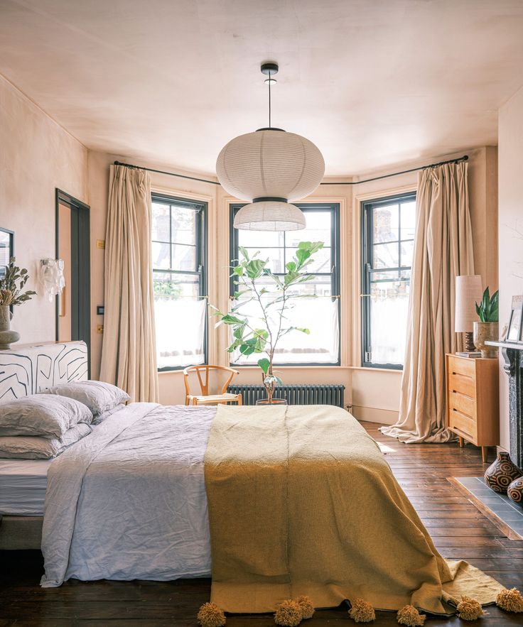 an image of a bedroom setting with furniture and decor in the photo, including a bed