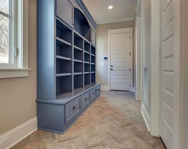 an empty walk in closet next to a white door