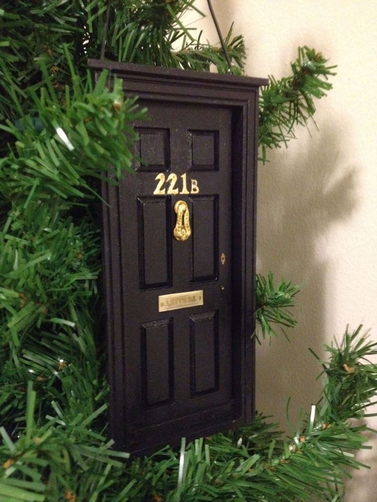 a black door is hanging on a christmas tree