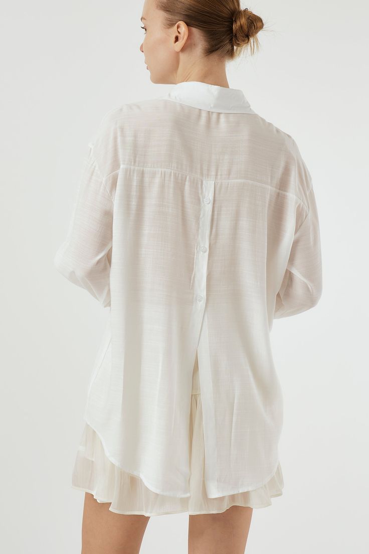 Sydney Back Open Shirt Button down style. Sheer, oversized shirt with open back detail. Professional Clean Only / Do Not Tumble Dry Model's height is 5′ 7″ (157cm) Bust 31in Waist 23in Hip 34in and wearing S/M Relaxed Fit Shirt With Shirttail Hem For Daywear, Oversized Effortless Shirt With Shirttail Hem, Summer Shirt With Shirttail Hem For Daywear, Summer Daywear Shirt With Shirttail Hem, Oversized Button-up Shirt For Daywear, Effortless Cotton Blouse With Shirttail Hem, Effortless White Button-up Blouse, White Relaxed Fit Blouse With Rolled Sleeves, Spring Shirt With Relaxed Fit And Shirttail Hem