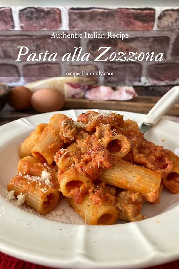 pasta with meat sauce and parmesan cheese on a white plate