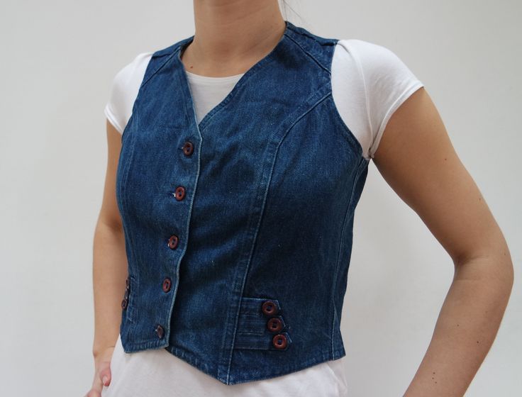 "Vintage Denim Vest Womens Blue Jeans Womens Denim Waistcoat Jacket Vintage Denim Sleeveless Vest Buttoning Short jeans vest. Blue denim vest with buttons in front.  Denim waistcoat. Blue jeans jacket without sleeves.  Measurements: Chest: 44cm / 17\" Waist: 41cm / 16\" Length: 56cm / 22\" Model: EU38 UK10 US6 Good vintage condition Please check measurements to insure a proper fit. Remember to allow yourself some extra room for movement.  If you have any questions feel free to ask. SHIPPING * I Medium Wash Casual Denim Vest With Buttons, Jacket Without Sleeves, Vest With Buttons, Women Waistcoat, Elegant Vest, Blue Jean Vest, Sleeveless Jean Jackets, Womens Denim Vest, Jeans Vest