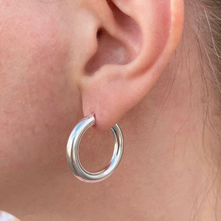 These chunky silver hoops are made of real 925 sterling silver so they will last for years to come.  Featuring a shiny silver finish, these beauties measure approximately 1 inch with a thickness of approximately 4mm. These are made with hollow tubing for a lightweight feel and have a secure latch closure. Each pair comes in a gift box.  925 Sterling silver 25mm diameter (approx 1 inch) 4mm thickness Secure latch closure Star And Moon Necklace, Thick Hoop Earrings, Moon Necklace, How To Make Notes, Shiny Silver, Silver Hoops, My Jewellery, 1 Inch, Gift Box