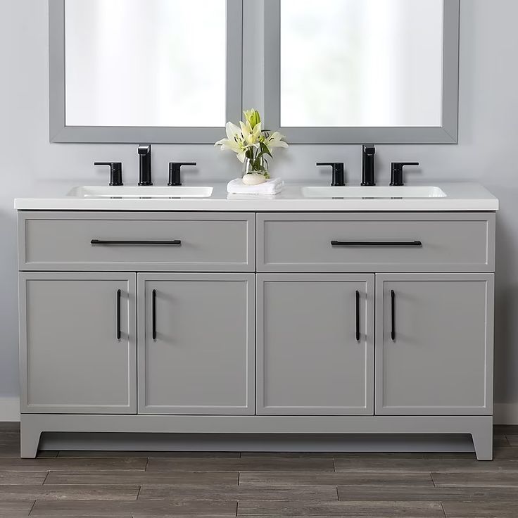 a bathroom with double sinks and mirrors on the wall next to each other in front of two windows