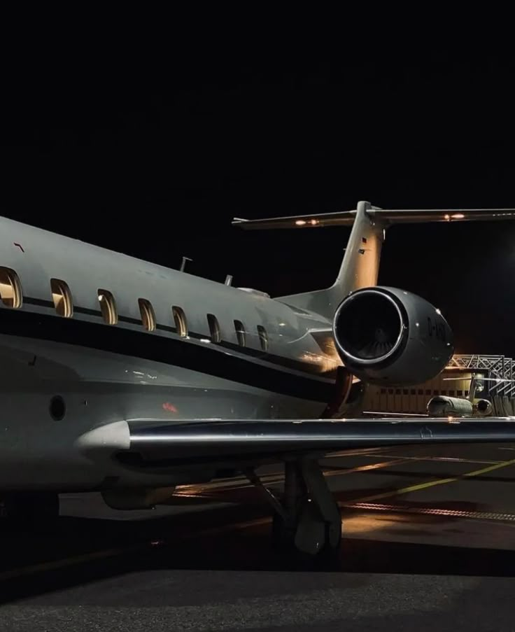 an airplane is parked on the runway at night