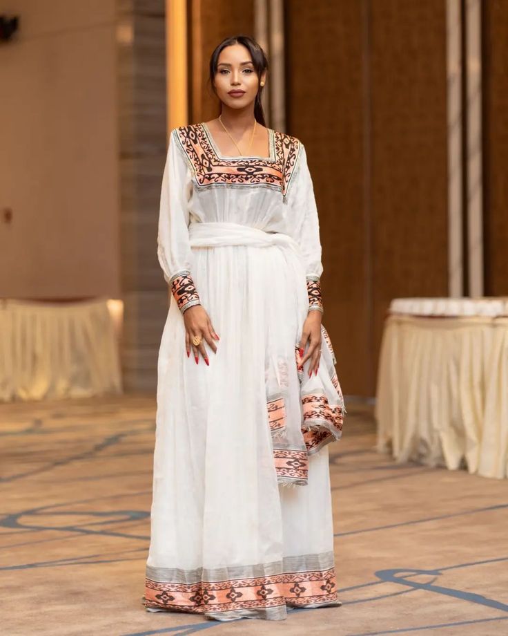 Description Step into timeless sophistication with our exquisite Menen fabric Habesha dress, blending modern simplicity with traditional Ethiopian charm. Crafted with delicate precision, this Habesha Kemis embodies the essence of grace and allure. Its light colors evoke a sense of ethereal beauty, accentuating the intricate patterns and flowing lines that define Ethiopian dress culture. Revel in the understated glamour of Ethiopian heritage with this captivating attire, designed to adorn you with effortless elegance. Material Cotton Menen Thread Estimated delivery : 2 weeks to 3 weeks Delivered to your door﻿ 14days return policy Free shipping to North America (The US & Canada), EU & UK, UAE & Qatar Contact WhatsApp +1(304)-306-2784Email: contact@ethiopian.store Elegant Dresses With Traditional Patterns For Navratri, Elegant Ceremonial Dresses For Navratri, White Embroidered Dress With Traditional Patterns, Elegant Dresses For Navratri Ceremonies, Elegant Dresses For Navratri And Traditional Ceremonies, Elegant Festive Embroidered Dress With Traditional Patterns, White Dabka Gown For Reception, Traditional Dabka Dresses For Reception, Elegant Saree For Traditional Occasions