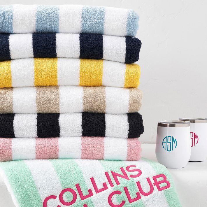 towels stacked on top of each other next to two coffee mugs