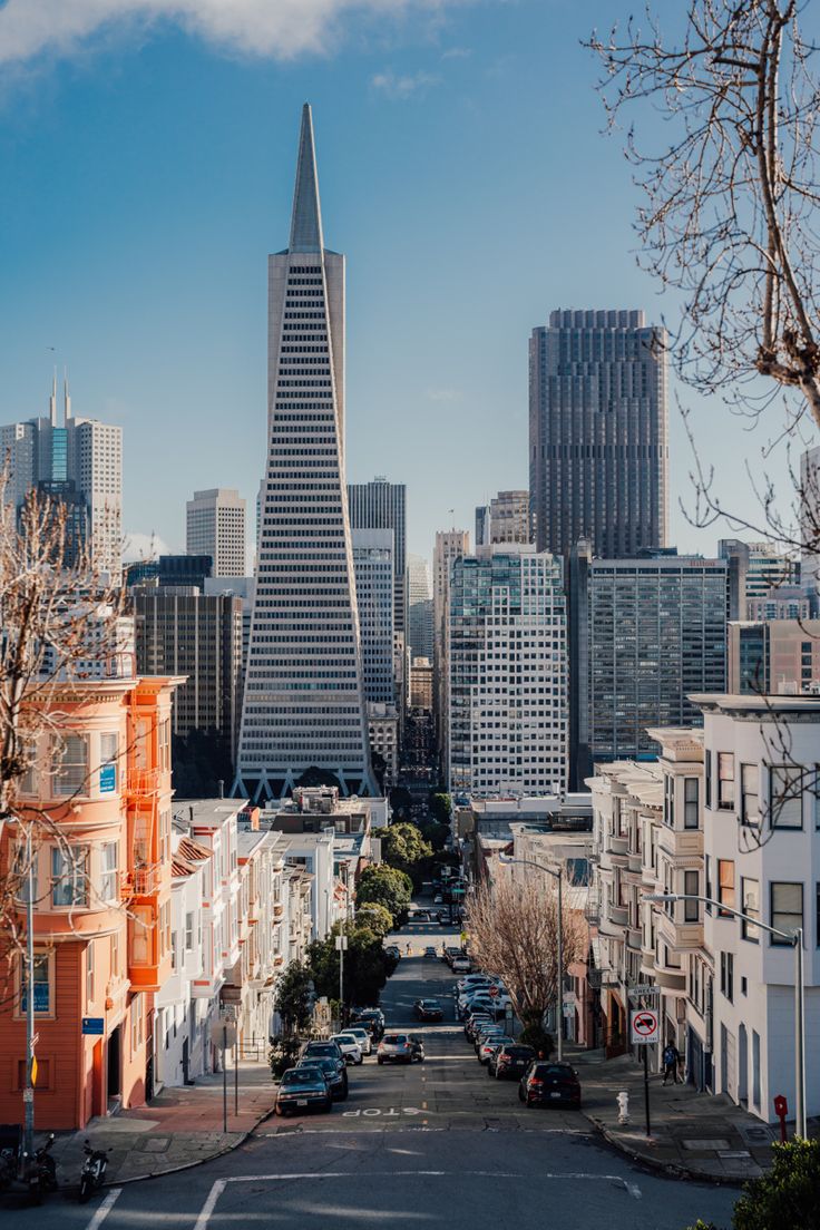 a city with tall buildings and cars parked on the street in front of each other