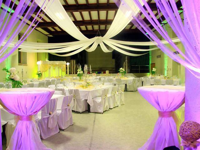 a banquet hall decorated with purple and white linens