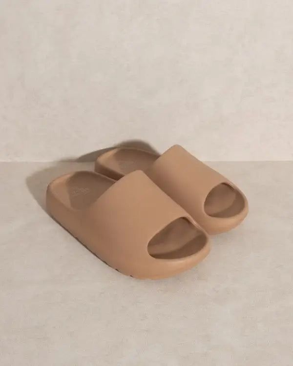 The OASIS SOCIETY Wyatt Comfort Slides offer the perfect combination of comfort and style. With an ultra-soft sole, these slides provide a luxurious and comfortable feel with every step. The chic design adds a fashionable touch to your casual look, making them versatile enough to wear with various outfits. Whether you're lounging at home or running errands around town, the Wyatt Comfort Slides are an excellent choice for keeping your feet both comfy and stylish. Slip into these slides and enjoy Comfortable Open Toe Platform Slippers With Textured Sole, Comfortable Cushioned Slide Platform Slippers, Comfortable Platform Slide Slippers With Textured Footbed, Comfortable Platform Slippers With Textured Footbed, Comfortable Slide Slippers In Solid Color, Comfortable Open Toe Platform Slippers With Cushioned Footbed, Comfortable Open Toe Slippers With Textured Sole, Beige Textured Slip-on Slides, Soft Slip-on Summer Slippers