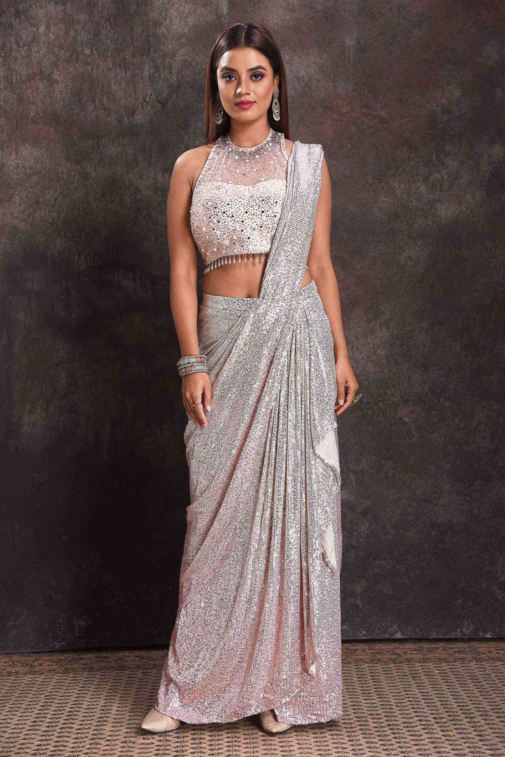 Buy beautiful silver sequin georgette pre-draped saree online in USA with designer blouse. Look your ethnic best on festive occasions with latest designer sarees, pure silk sarees, Kanchipuram silk sarees, designer dresses, Anarkali suits, gown, embroidered sarees from Pure Elegance Indian fashion store in USA.-full view Silver Embellished Pre-draped Saree, Silver Georgette Pre-draped Saree For Wedding, Designer Silver Sequined Choli, Festive Silver Pre-draped Saree With Unstitched Blouse, Glamorous Silver Sequined Choli, Silver Sequined Choli With Traditional Drape, Silver Sequined Traditional Drape Choli, Elegant Silver Saree With Mirror Work, Elegant Silver Pre-draped Saree With Mirror Work