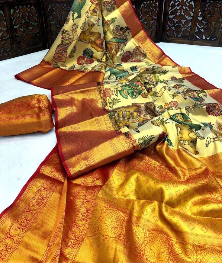 Kalamkari saree with gorgeous motifs depicting rural life in India. The saree has rich borders, a very grand pallu, as well as a stitched blouse. Statement saree! Anarkali Pre-draped Saree With Printed Border For Festivals, Semi-stitched Traditional Wear With Printed Border, Festival Pre-draped Jamawar Saree With Motifs, Multicolor Dola Silk Pre-draped Saree With Motifs, Navratri Puja Pre-draped Saree With Printed Border, Navratri Dola Silk Pre-draped Saree With Traditional Patterns, Yellow Semi-stitched Saree With Printed Border, Semi-stitched Yellow Saree With Printed Border, Art Silk Saree With Kalamkari Print In Traditional Drape