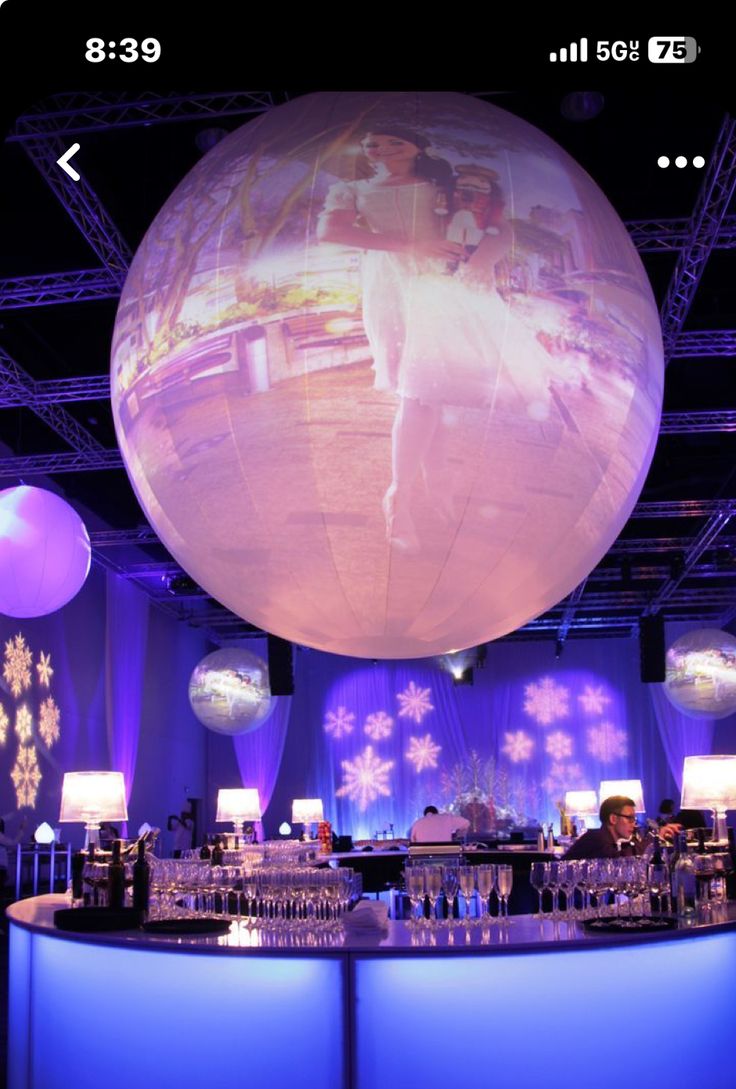 the bar is decorated with blue lights and snowflakes on the wall behind it