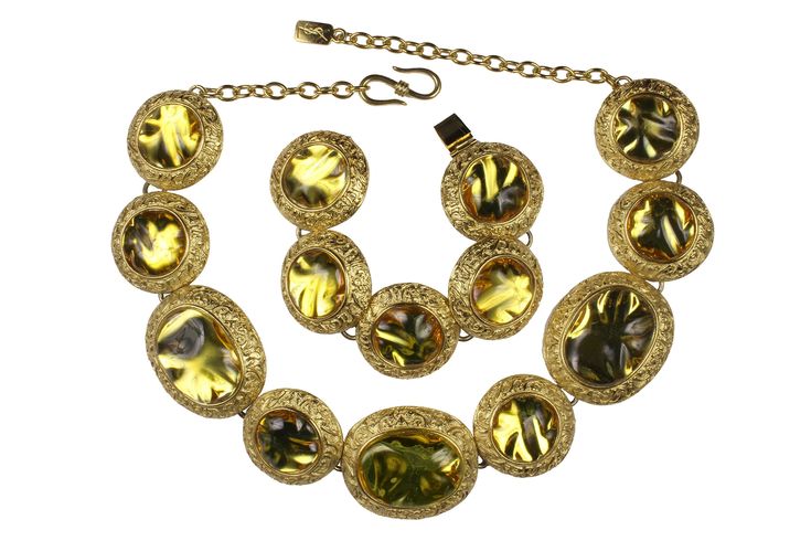 Vintage 1980's YVES SAINT LAURENT, made in France by Robert Goossens, byzantine style, irregular amber resin cabochons alternating oval and circular medallions, on the necklace and with circular medallions for the bracelet, with gold plated metal. Necklace adjustable hook closure, with signature YSL, and bracelet signed on the back in one of the medallions. CONDITION: Excellent DIMENSIONS: Necklace: Height: 4,8cm / Total Length: 57cm Bracelet: Height: 3,8cm / Total Length: 20cm More vintage item Gold Vintage Cabochons, Vintage Oval Gold Cabochons, Formal Gold Lucite Jewelry, Vintage Yellow Jewelry With Cabochon, Vintage Yellow Cabochon Jewelry, Saint Laurent Vintage, Amber Resin, Heart Pocket, Necklace And Bracelet Set