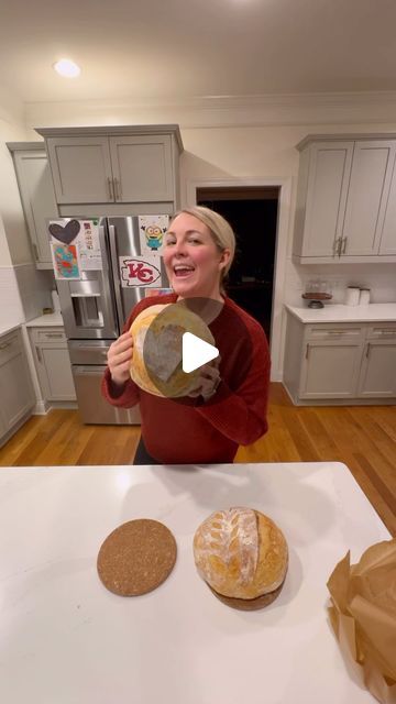 a woman is holding some bread in her hands while standing next to two other pastries