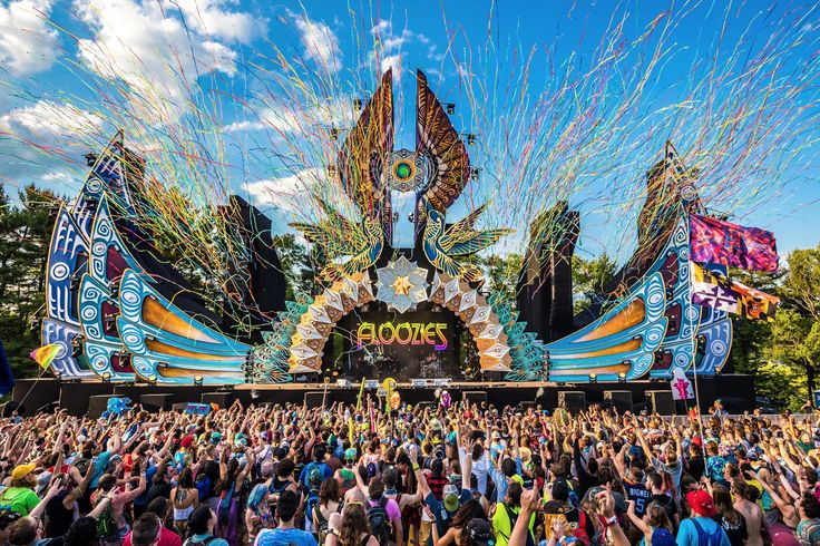 a large group of people standing in front of a stage