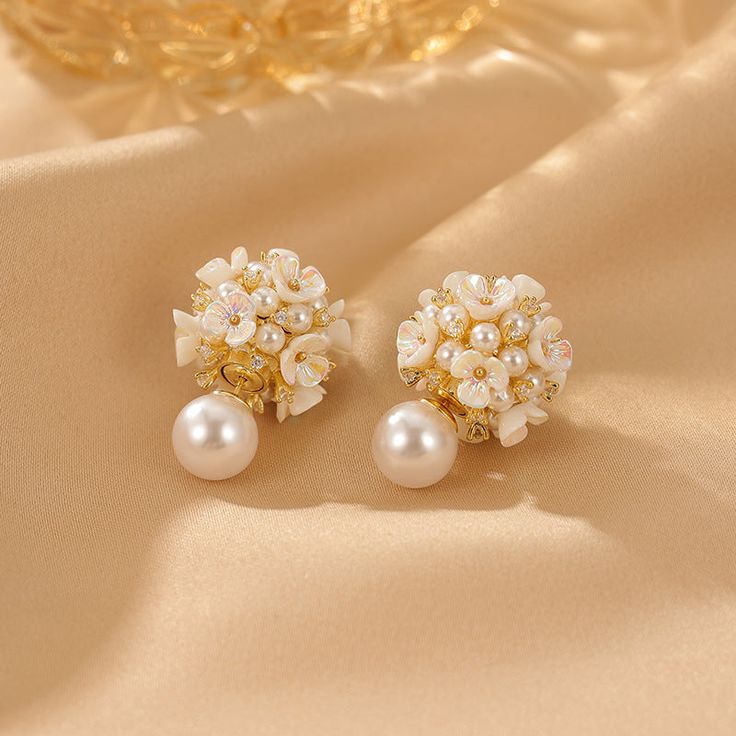 ✦ Indulge in the romance of our elegant stud earrings adorned with a delicate flower pearl design, perfect for adding a touch of grace to your wedding ensemble or elevating your bridesmaid look. Crafted with meticulous detail, these earrings encapsulate the essence of romance, making them an ideal choice for those special occasions. The timeless appeal of the flower pearl design adds a subtle and sophisticated charm, making these earrings a versatile accessory for various elegant events. Whether Feminine Pearl White Earrings, Feminine Pearl White Bridal Earrings, Elegant Pearl Button Earrings For Wedding, White Feminine Pearl Earrings For Formal Occasions, Feminine Pearl White Drop Bridal Earrings, Feminine Pearl Drop Flower Earrings, Feminine White Flower Earrings With Pearl Drop, Pearl White Pearl Clip-on Earrings For Wedding, Pearl White Flower Drop Earrings