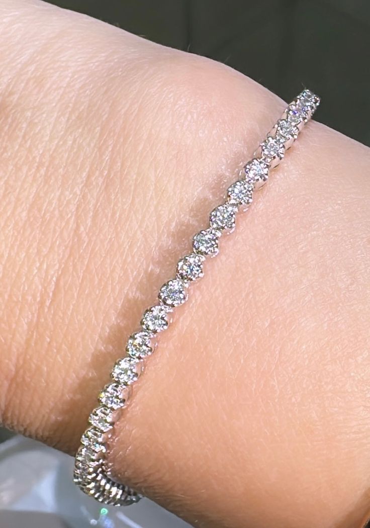 This beautiful Diamond Riviera Line Tennis Bracelet offers sparkling sophistication for any occasion with 1.95ct t.w. of dazzling diamonds, it will make you shine with undeniable elegance. Make your statement of style today! Metal: 14K White GoldDiamond Weight: Rounds Brilliant cuts 1.95ct t.w.Bracelet Length: 18cmLock: Box Catch With Hidden Safety Estimated production time is 4 - 5 weeks. Classic Sparkling Diamond Bracelet For Anniversary, Classic Sparkling Diamond Bracelet, Classic Diamond Bracelet With Sparkling Detail, Elegant Sparkling Diamond Bracelet For Anniversary, Elegant Sparkling Diamond Bracelet, Elegant White Gold Sparkling Diamond Bracelet, Classic Sparkling White Gold Bracelets, Elegant White Sparkling Diamond Bracelet, Fine Jewelry Sparkling Bracelet For Anniversary