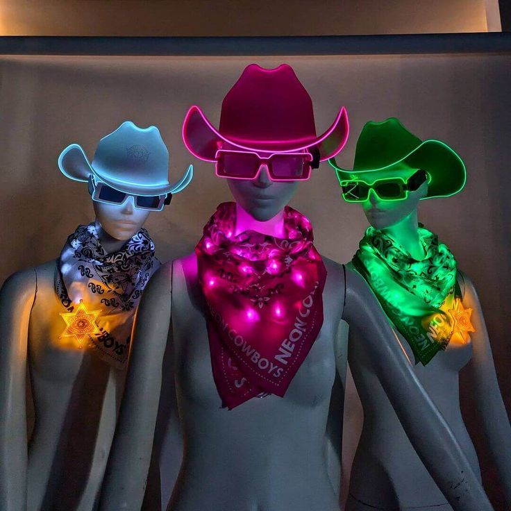 three mannequins wearing neon lights and hats