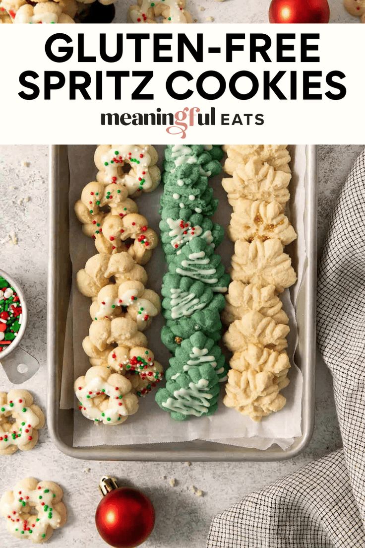 gluten - free spritz cookies in a tray with christmas decorations