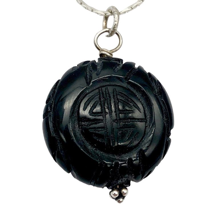 "Exquisite Carved Long Life Black Obsidian Pendant Elevate your jewelry collection with this exceptional Black Obsidian pendant, carved with the Chinese Long Life character. This intricately detailed pendant offers a striking contrast and a symbol of hope and longevity. The rich black hue of the Black Obsidian pendant complements a wide range of jewelry styles. The pendant is meticulously carved with the Chinese Long Life character, and the detailing on both the front and back is simply exquisit Artisan Carved Jewelry For Meditation, Obsidian Pendant Amulet Necklace, Obsidian Amulet Pendant Necklace, Artisan Black Round Pendant Jewelry, Carved Amulet Necklace With Round Pendant, Carved Round Pendant Amulet Necklace, Black Carved Round Jewelry, Black Carved Jewelry Gift, Spiritual Carved Round Pendant Necklaces