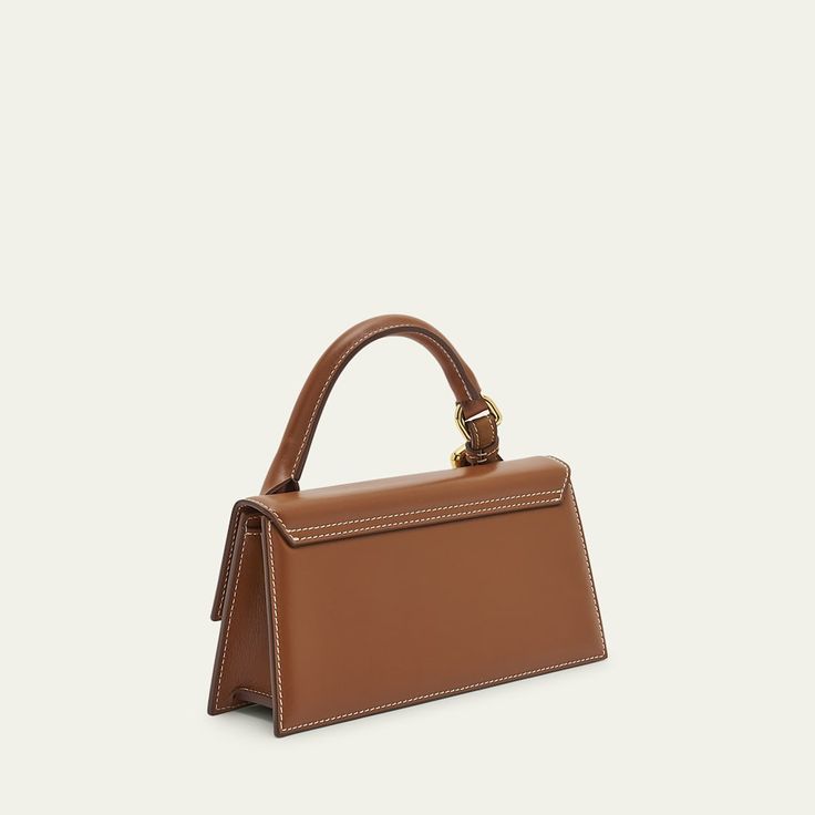 Jacquemus "Le Chiquito Long" crossbody bag in leather and cotton  Rolled top handle  Detachable, adjustable crossbody strap Can be worn as a top handle or crossbody bag  Flap top with magnetic closure  Lining: Cotton Approx. 6.8"H x 8.5"W x 3.9"D Made in Australia High-end Top Handle Baguette Bag With Removable Pouch, Tan Satchel Box Bag With Detachable Strap, Timeless Top Handle Baguette Bag With Removable Pouch, Tan Box Shoulder Bag With Detachable Handle, Evening Crossbody Baguette Bag With Top Carry Handle, Everyday Top Handle Baguette Bag, Timeless Top Handle Baguette Bag With Gold-tone Hardware, Tan Box Bag With Detachable Handle, High-end Top Handle Box Bag With Detachable Strap