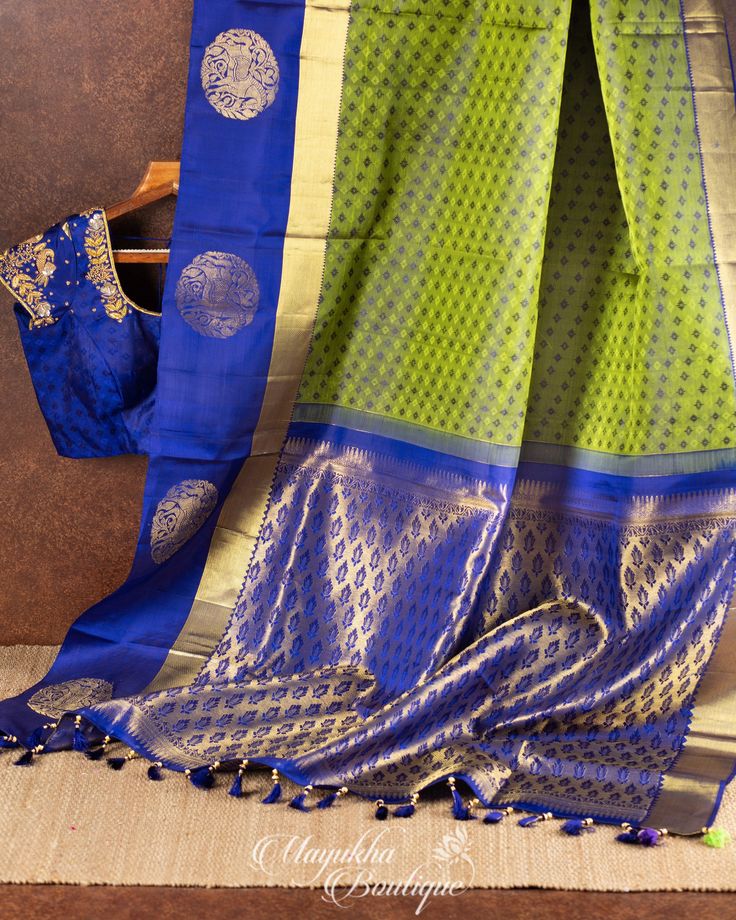 "One of the beautiful combinations in Pure silk Authentic Kanchipuram Silk Saree in Moss Green color with minimalistic woven Self Brocade Koravai with Dark Blue borders having Horse weave all over the borders complemented with Intricate hand worked blouse in size 38\" FACTS ABOUT THE MOTIFS: KUTHIRAJ: Horses galloping across the border of this Kanchipuram Silk sari form a stunning pictorial panel. This magnificent creature is a predominant feature of the mandapams of temples. The horse is also c Pista Green Blouse Piece With Zari Weaving For Navratri, Pista Green Anarkali Blouse Piece With Zari Weaving, Anarkali Blouse Piece In Pista Green With Zari Weaving, Anarkali Pista Green Blouse Piece With Zari Weaving, Pista Green Handloom Chanderi Blouse Piece, Pista Green Zari Weaving Blouse Piece For Designer Wear, Pista Green Tussar Silk Handloom Blouse Piece, Designer Art Silk Blouse Piece In Pista Green, Pista Green Tussar Silk Blouse Piece With Zari Weaving