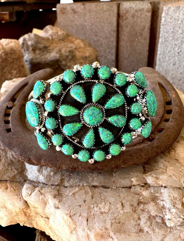 This Cluster Cuff is so beautiful with 31 stones inlaid in .925 sterling silver all handmade in the USA, choose from our colors Hot Pink Opal, Neon Green, Campitos Blue and White Buffalo! Southwestern Multi-stone Cuff Bracelet, Southwestern Multi-stone Bracelet Jewelry, Southwestern Multi-stone Bangle Cuff Bracelet, Southwestern Multi-stone Cuff Bangle Bracelet, Artisan Multi-stone Bangle Jewelry, Western Style Bangle Jewelry Gift, Western Style Bangle Jewelry As Gift, Western Style Bangle As Gift, Southwestern Silver Multi-stone Bracelet