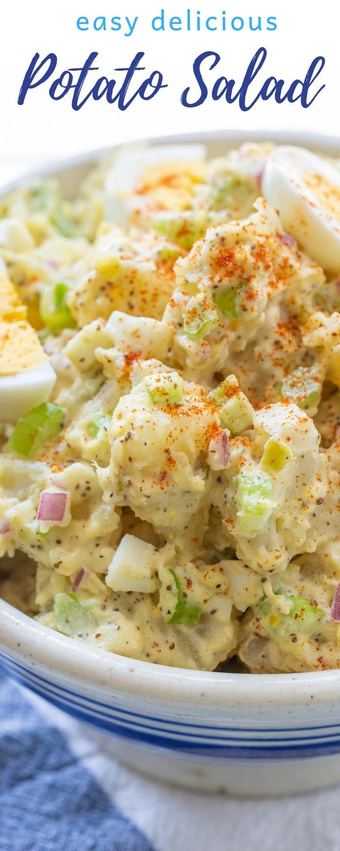 potato salad in a white bowl on a blue and white checkered table cloth with text overlay