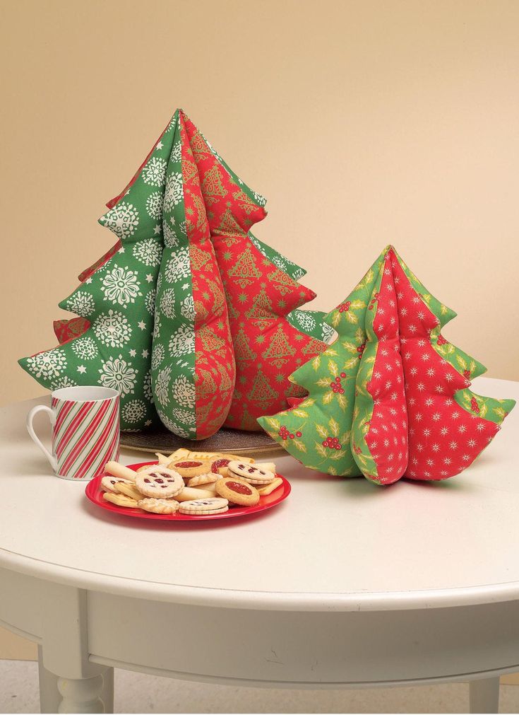 three christmas trees and cookies on a table