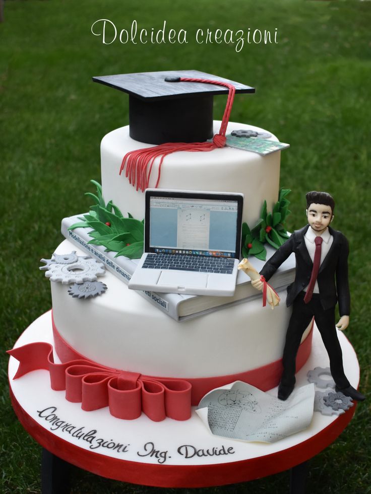 a graduation cake with a laptop on top