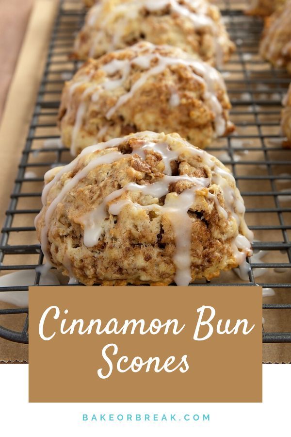 cinnamon bun scones with icing on a cooling rack