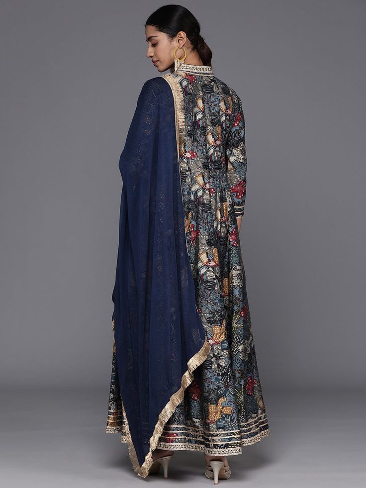 Grab this beautiful 2-piece set. The set comes with floral print & gota patti detailing anarkali kurta has v neck, 3/4th sleeves & calf length teamed with silk chiffon dupatta with lace detailing. Color - Navy Blue Kurta Fabric-Silk Dupatta Fabric - Silk Chiffon Neck-V Neck Sleeves-3/4th Sleeves Work - Floral Print & Gota Detailing Washing Instructions-Hand Wash DISCLAIMER - The color of the product may be differ due to screen settings of device. A misprint here and a color drop slip there is th Bollywood Style Floral Print Sets For Eid, Anarkali Palazzo Set With Straight Kurta And Floral Print, Straight Kurta Anarkali Set With Floral Print For Festivals, Diwali Floral Print Straight Kurta Salwar Kameez, Navratri Floral Print Straight Kurta Set, Navratri Straight Kurta Sets With Floral Print, Diwali Floral Print Straight Salwar Kameez, Diwali Semi-stitched Anarkali Set With Kalamkari Print, Floral Anarkali Set For Eid