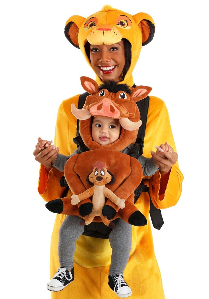 a woman in a lion costume holding a baby wearing a kangaroo costume on her chest