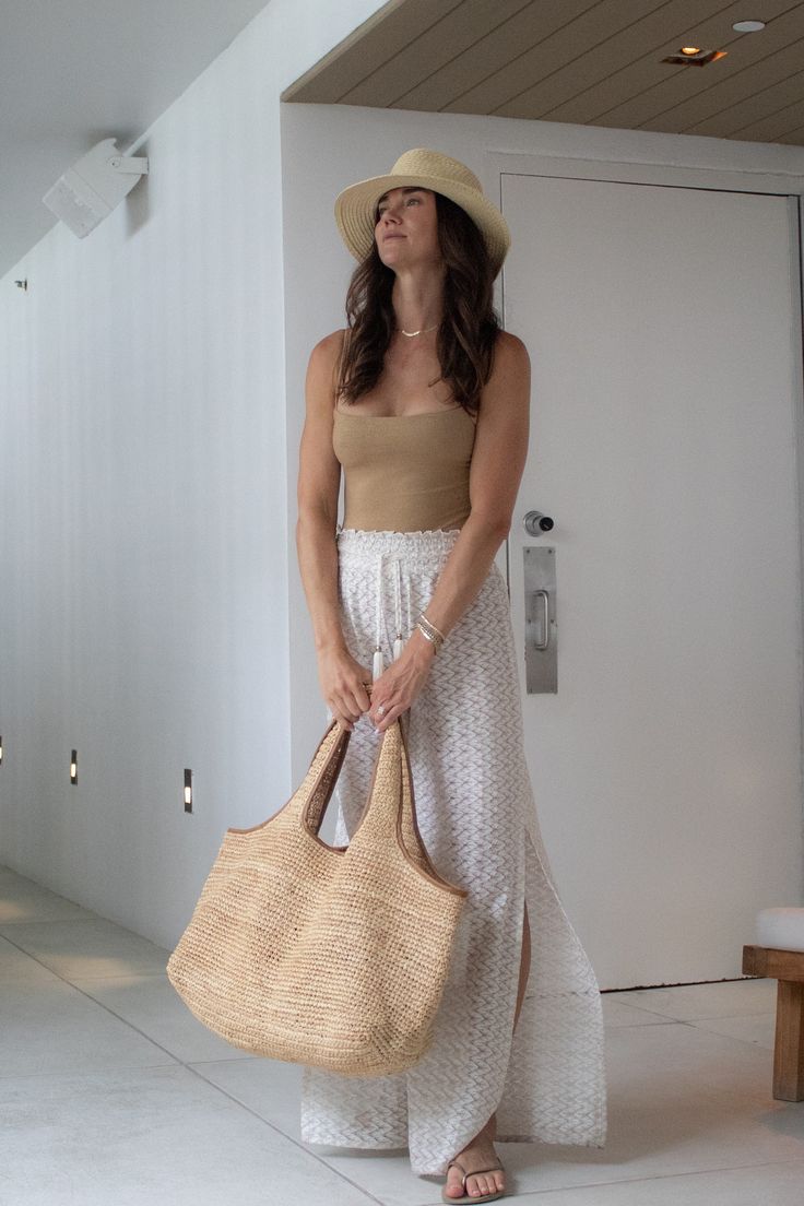 Introducing our newest addition to the Anya & Niki collection: The Biscayne Straw Bag. Expertly hand crafted with crocheted raffia, this extra large bag features luxurious tan saddle leather trim and a branded luggage tag for a touch of style. Designed for the modern traveler, it deconstructs easily to fold flat, making it perfect for packing. The wide straps ensure comfortable wear over your shoulder or for carrying like a tote. Whether you're exploring a new city or heading to the beach. Embra Natural Woven Leather Hobo Bag For Travel, Elegant Woven Leather Beach Bag For Travel, Chic Neutral Tote Beach Bag, Chic Handwoven Hobo Bag For Vacation, Chic Handwoven Hobo Tote Bag, Natural Woven Leather Bag For Day Out, Chic Natural Hobo Bag For Travel, Chic Crochet Bag With Leather Handles For Vacation, Chic Handwoven Straw Bag For Travel