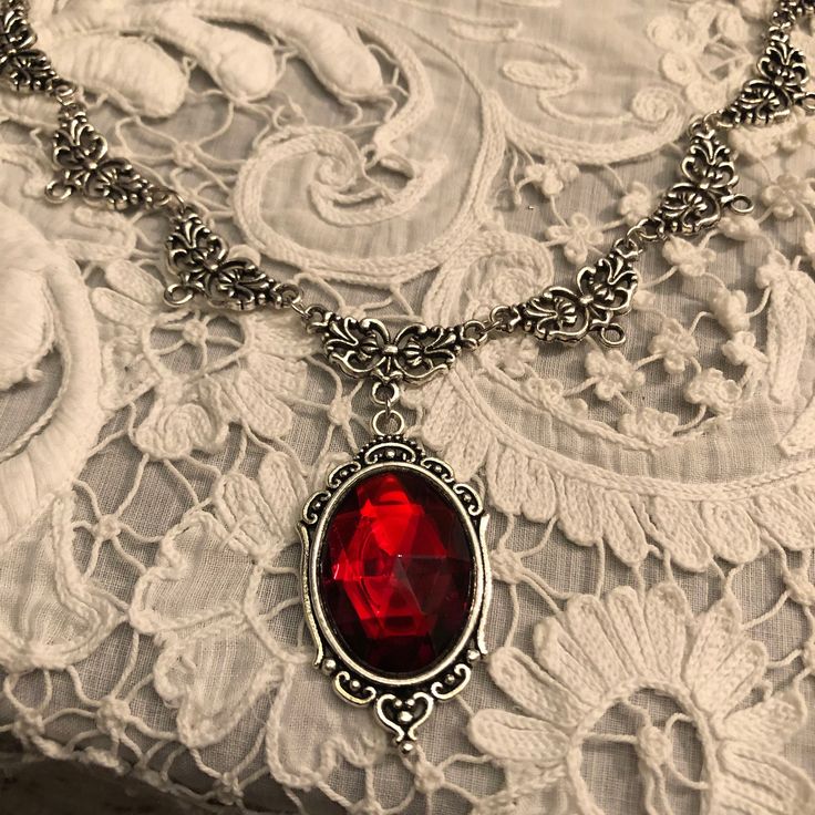 CHARLOTTE Filigree VICTORIAN Style Deep Red Acrylic Crystal Silver coloured Necklace.  Set also listed with choice of earring sizes I am also listing them in gold plate and dark gold plate ( bronze colour) PENDANT APPROX  1.75 INCHES (4cm) INCLUDING BAIL LENGTH OF NECKLACE...16..INCHES (40cm)  AS SHOWN...OTHER LENGTHS AVAILABLE 18, 20 , 22 , 24 (45,50,55,60 cm) Also listed as a set with earrings. (CHOICE OF 2 SIZES! Long or Large) ....PLEASE SEE OTHER LISTING FOR THE SET. I AM LISTING necklaces Fantasy Jewelry Magic, Earring Sizes, Rockstar Aesthetic, Romantic Goth, Red Accessories, Metal Necklace, Dark Gold, Fantasy Jewelry, Metal Necklaces