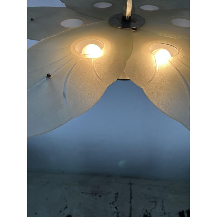 a ceiling lamp with two lights on it's sides and one light in the middle