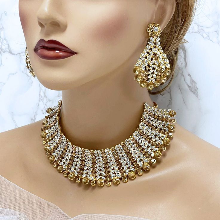 Champagne Indian Wedding Jewelry Set, Bridal Choker Necklace, Kundan Jewelry for Bollywood Bride Gift, Bridal Indian Jewelry Set, Champagne Kundan Choker Necklace, Kundan Jewelry Set, Champagne Indian Bridal Choker, Bollywood Style Wedding Jewelry Gift This elegant Champagne Indian Wedding Jewelry Set is the perfect choice for any bride who wants to embrace traditional beauty with a touch of glamour. The set includes a stunning choker necklace and matching earrings, beautifully crafted with spar Jeweled Round Bridal Earrings For Wedding, Gold Jeweled Bridal Necklace For Reception, Gold Bridal Earrings For Wedding And Diwali, Gold Bridal Earrings With Stone Work For Party, Gold Hand Set Bridal Accessories For Reception, Gold Hand-set Bridal Earrings For Wedding, Gold Hand Set Bridal Earrings For Wedding, Gold Crystal Bridal Necklace For Celebrations, Crystal Gold Jewelry Sets For Receptions