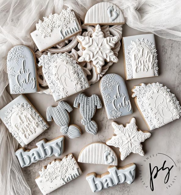 baby shower cookies decorated with frosting and icing on top of a white table