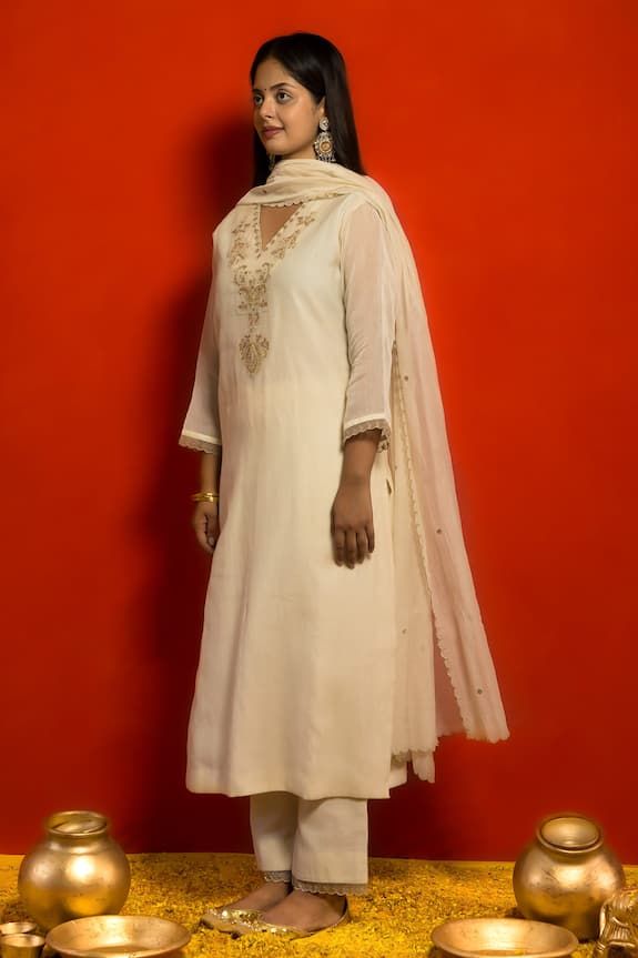 Ivory pure malai chanderi kurta with vintage pattern, contrast zari and zardozi placement embroidery. Paired with straight fit pant and scalloped embroidered dupatta. - Aza Fashions Unstitched Elegant Churidar With Embroidered Border, Elegant Unstitched Churidar With Embroidered Border, Elegant Festive Salwar Kameez With Embroidered Border, Chanderi Straight Kurta With Embroidered Border, Chanderi Salwar Kameez With Embroidered Border And Long Sleeves, Straight Chanderi Kurta With Embroidered Border, Elegant Mulmul Kurta With Zari Work, Elegant Cotton Anarkali Set With Gota Work, Elegant Mulmul Churidar For Diwali